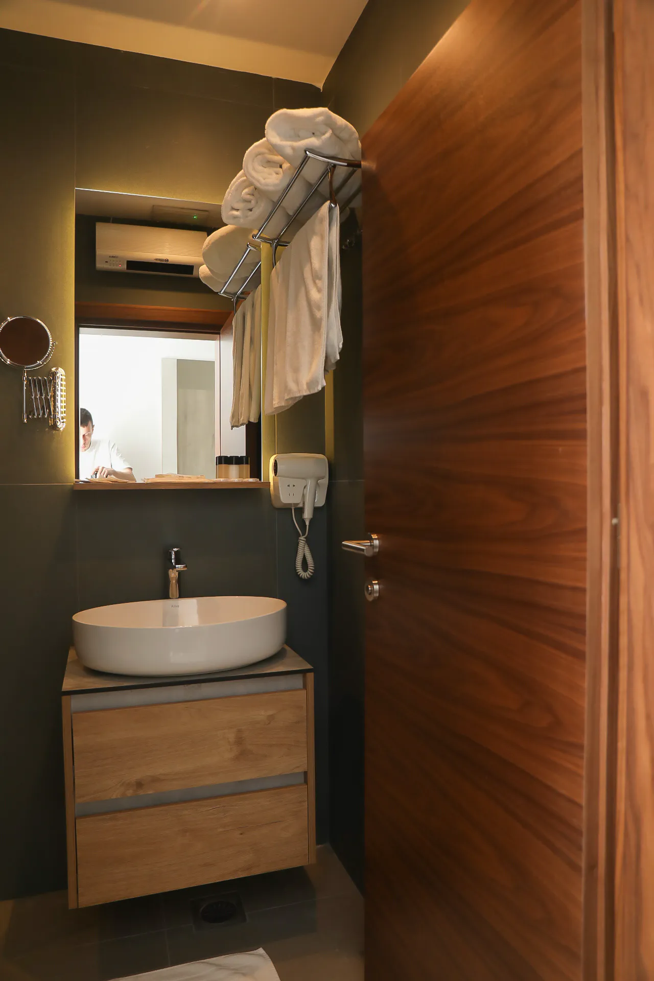 A basin, mirror and shower in a Coconut bathroom