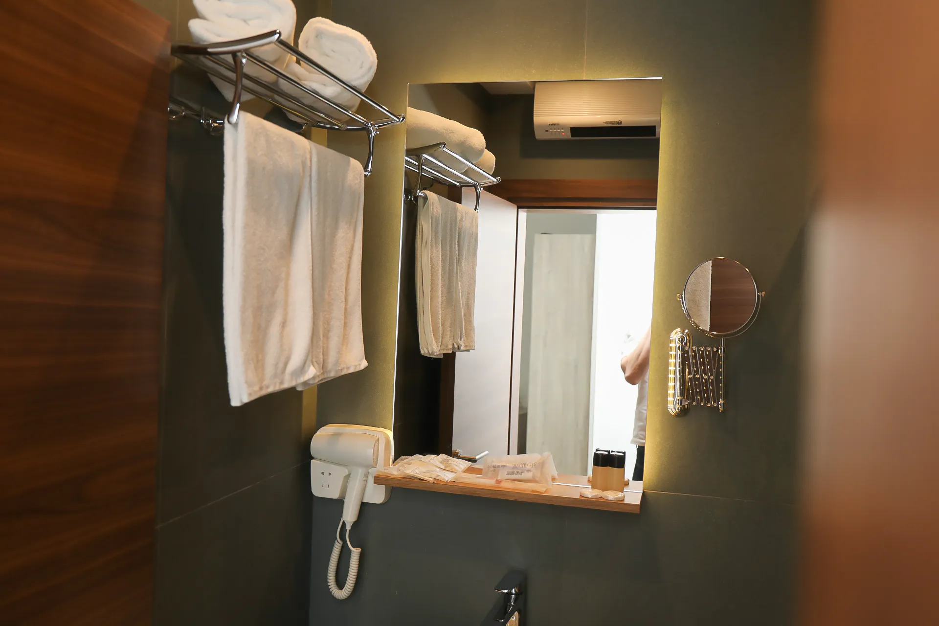 A basin, mirror and shower in a Coconut bathroom