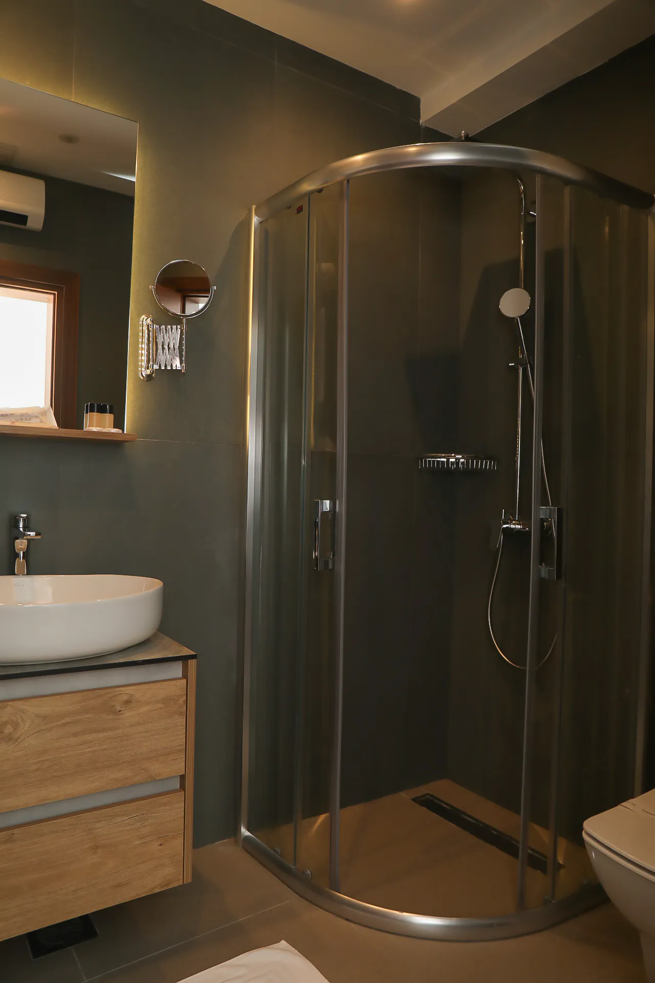 A basin, mirror and shower in a Coconut bathroom